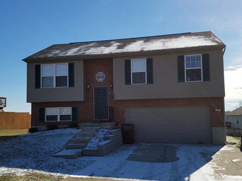 a brick house with snow on the ground